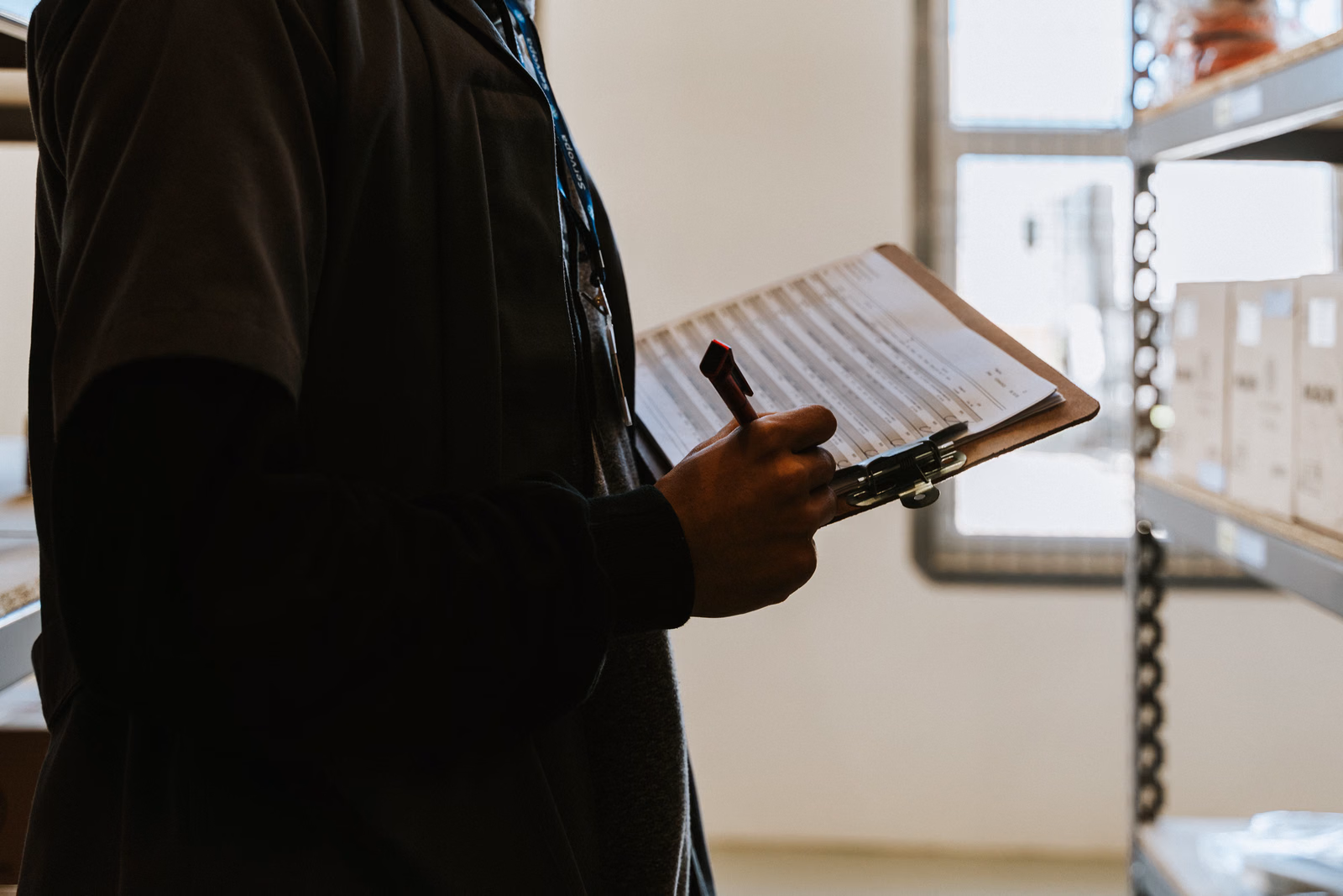 Professional completing a checklist during an inventory and inspection operation