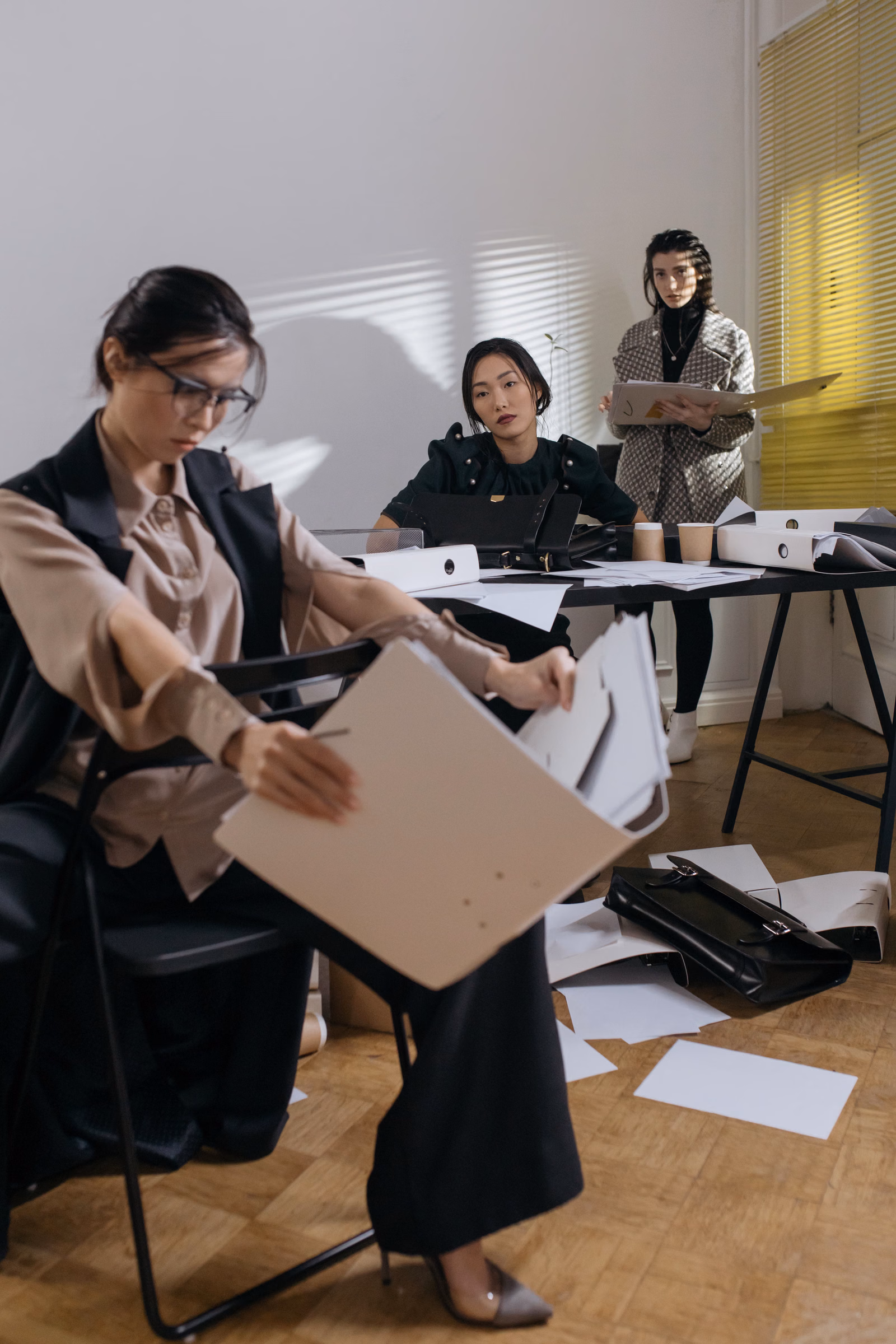 Office team reviewing folders and documents during an internal review
